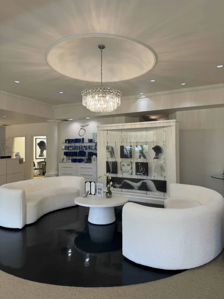 a room with white furniture and a chandelier